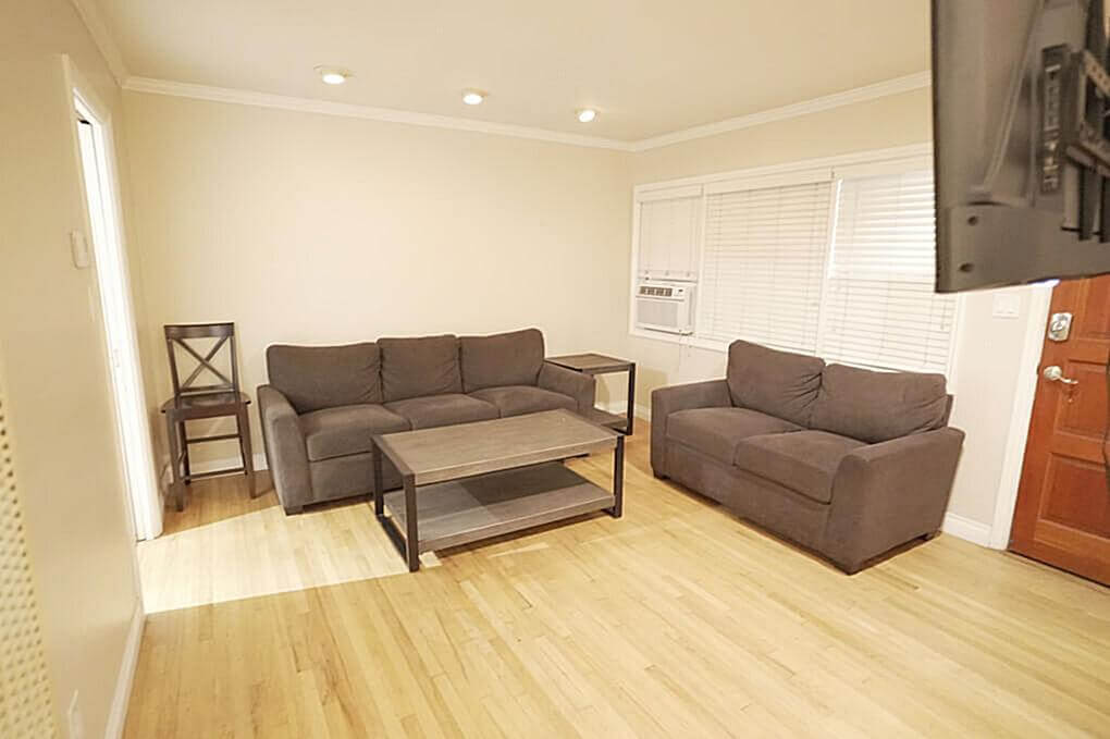 Comfort & Relaxation at the Halfway House A cozy living room in a halfway house with a comfy sofa and TV