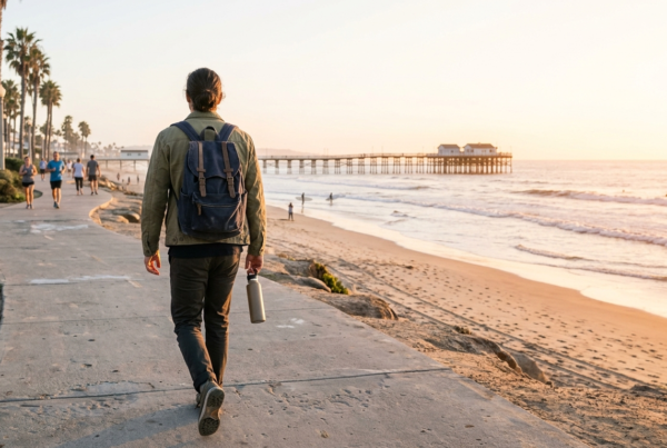 Person with a backpack heading out along the Pacific Beach boardwalk, a fresh start using the San Diego WorkReady Hub