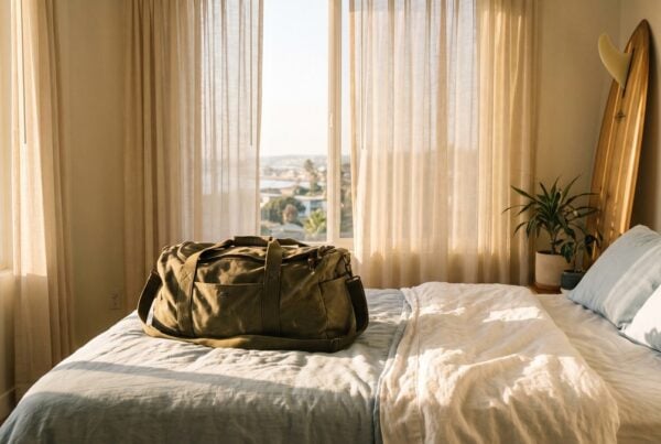 Packed duffel bag on a made bed on move-in day for a first week in sober living