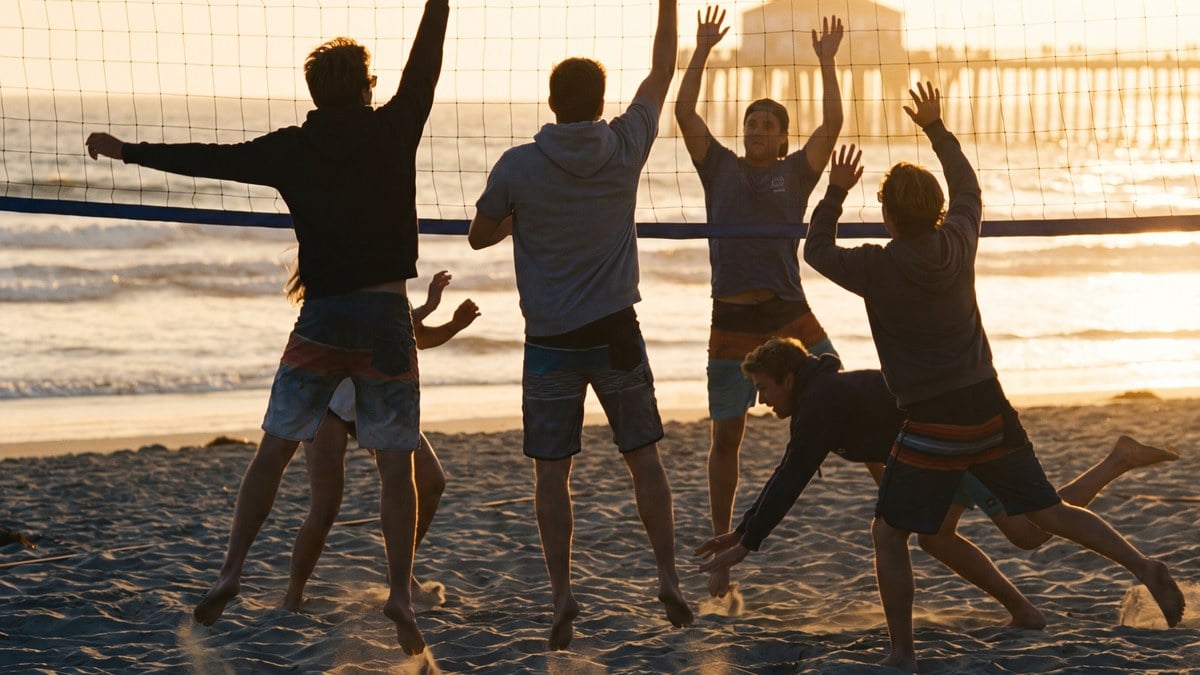 Young adults playing beach volleyball at golden hour near young adult sober living in San Diego